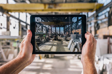 Man Taking Photo with Computer Tablet at Work
