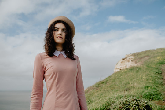 Young woman posed near a cliff