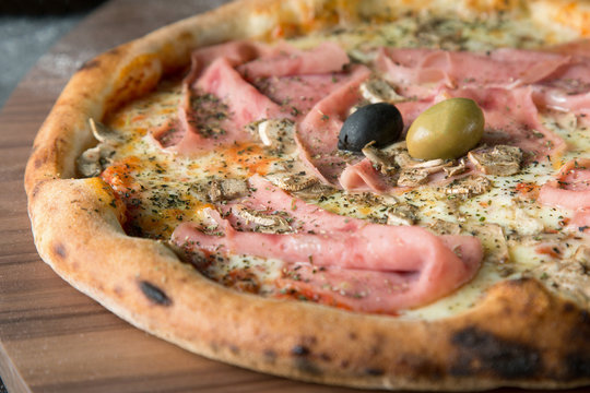 Italian pizza with salami and olives