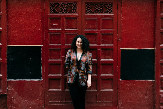 disability fashionable woman smiling in the red wall