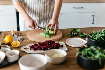 Anonymous cutting avocado for meals