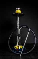 hookah on an Apple, orange slices in a flask and blue syrup. beautiful metal shisha on black isolated background