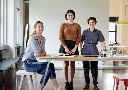 Portrait of a three women in a modern studio office.