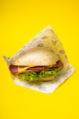 Sandwich on the yellow background. Fastfood. Burgeer.