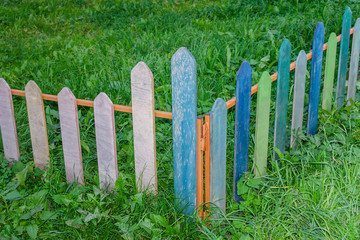 Small multicolored wooden fence, each plate of a different color. Horizontal frame