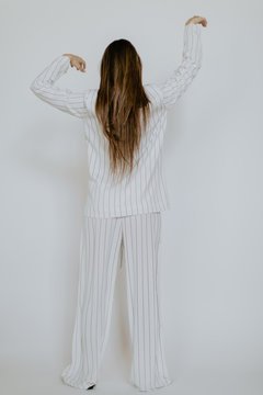 Faceless girl alone in striped pajamas