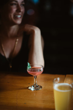 Smiling woman having drinks at the bar