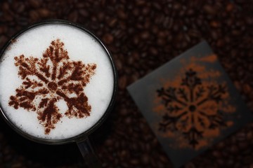 Christmas cappuccino with cinnamon and coffee beans