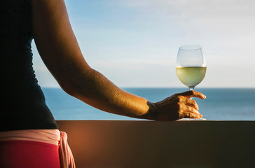 Woman Holding Wine Glass by the beach