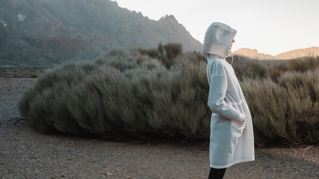 Faceless Model Wearing Futuristic White Coat In The Volcanic Scenery
