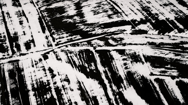 Armenian Spring - abstract drone shot of a field with snow blown out by the wind
