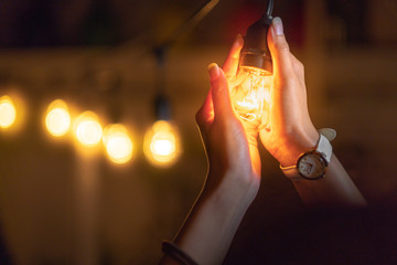 Girl holding a lightbulb