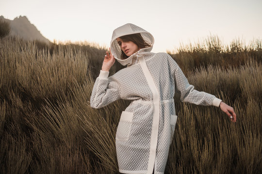 Fashion Model Wearing Futuristic White Coat With Hood