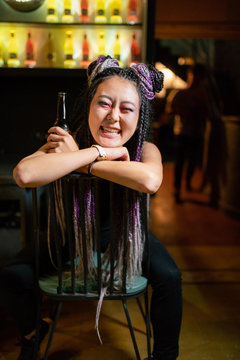 Happy girl sitting backwards in a bar