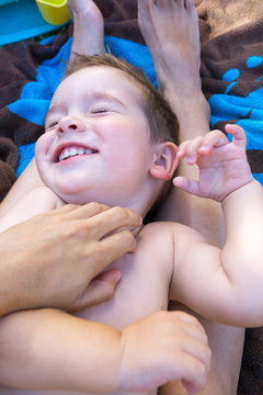 Boy laughing while being tickled