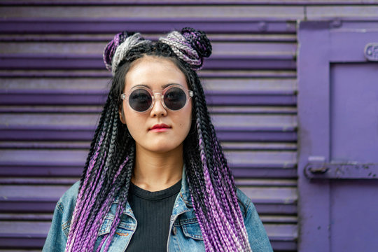Asian girl with sunglasses and purple background