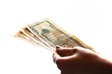 Woman hand giving money like bribe or tips isolated on white background. USD currency banknotes...