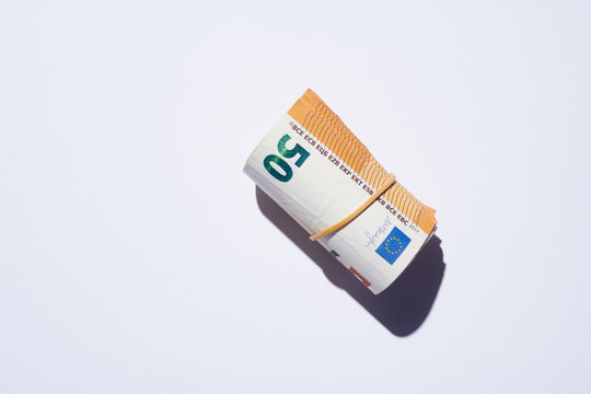 Rolled euro banknotes in rubber band