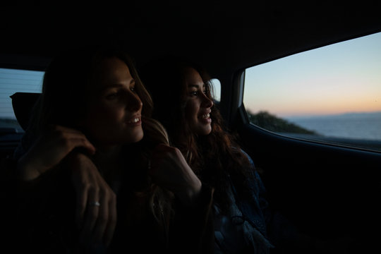 Two girls sitting in the car enjoying the last lights of the day
