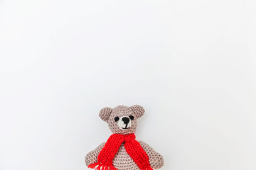 Simply minimal design with toy bear in red scarf isolated on white background. Children care materinity family concept. Flat lay, top view, copy space