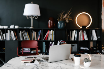 Laptop on table in stylish library