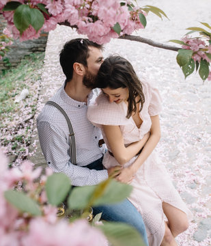 Young couple having picnic under cherry tree