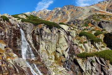 The beautiful Skok waterfall with the mountains of High Tatras near to Strsbke Pleso in Slovakia © andras_csontos