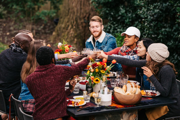 Friends toasting during an outdoor dinner party