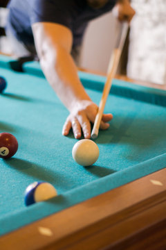 Man Playing Billiards In A Pool Table