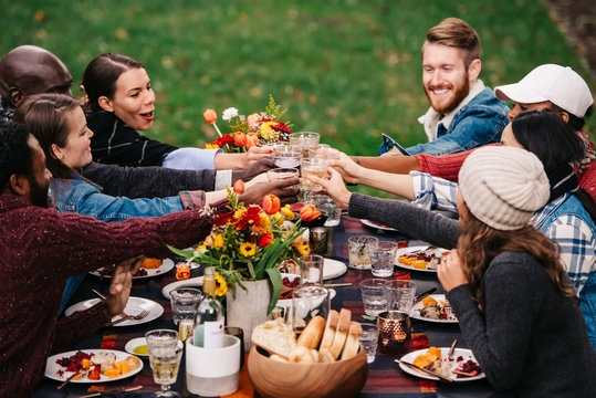 Friends toasting during an outdoor dinner party