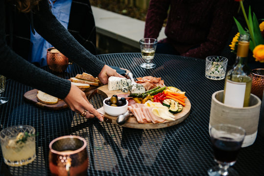Woman placing crudites on a patio table