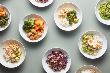 Composed bowls of prepared meals