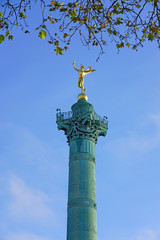 Fototapeta na wymiar View of the green blue bronze July Column statue on the Place de la Bastille in Paris commemorating the French revolution