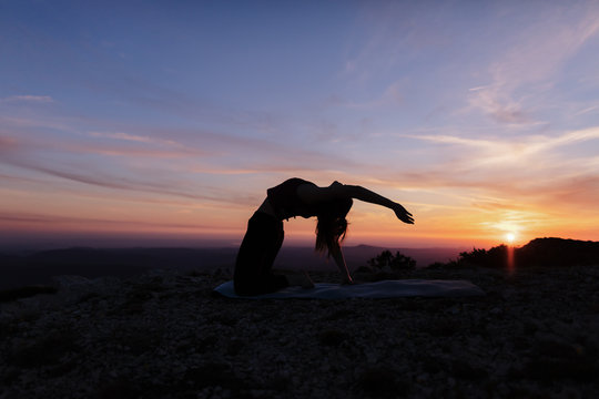 Woman Doing Yoga on Mountain Cliff