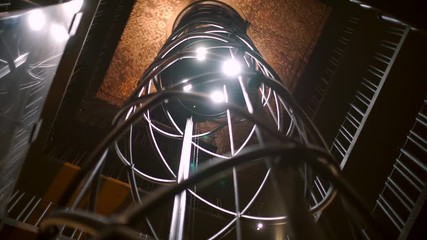 The movement of the elevator in the shaft down. 