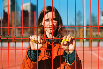 Young woman with red cage