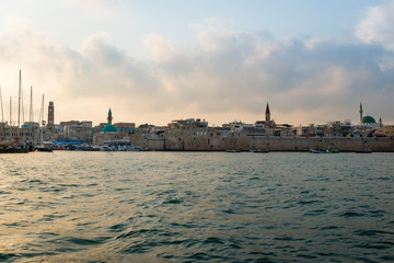 Obraz na płótnie Canvas View of the fortification of the old city Akko from boat. Israel.