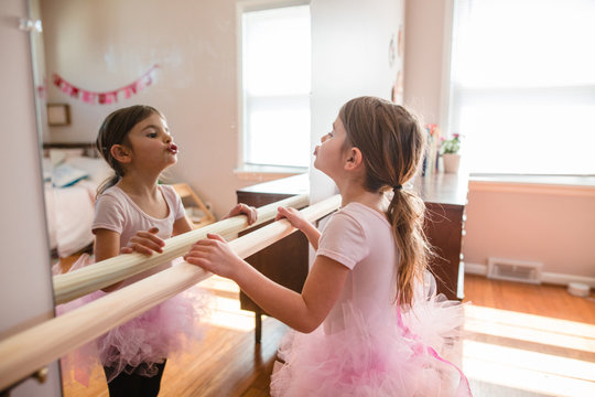 Little girl practices ballet in her room
