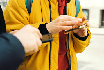 Two anonymous man with phones