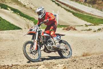 Close-up of mountain motocross race in dirt track in day time. Concept focus of during an acceleration in action sport