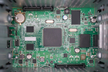 Electronic components on a green motherboard