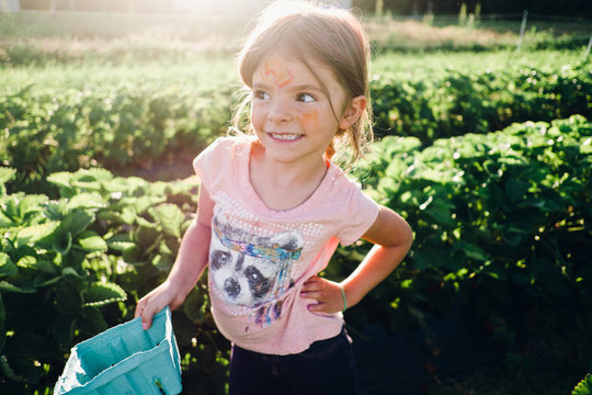 child picking strawberries