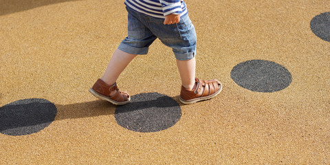 Young child walking alone along path