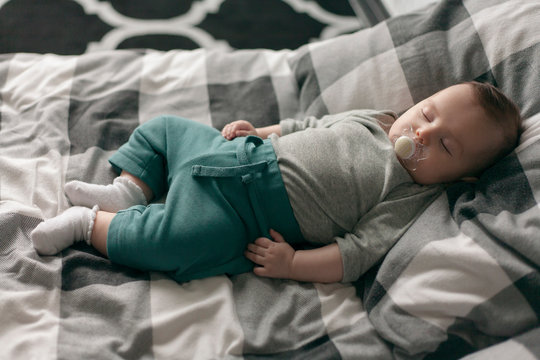 portrait of a sleeping newborn baby on the bed