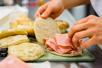 Chef Preparing Savory Focaccia with Mortadella Sausage