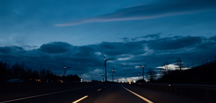 Blur dramatic sky with windmills in the background