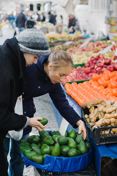 Woman choosing vegetables in shop