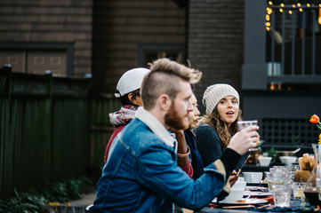 Girl throwing a flirtatious glance towards a boy at dinner