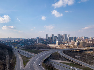 Road junction and new buildings under construction of Pechersk District, city Kiev Ukraine on a background of blue sky. Aerial view from drone.