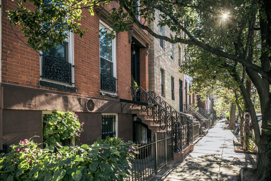 Horizontal Sidewalk View of Williamsburg Residential Neighborhood in Brooklyn with Brownstone Homes